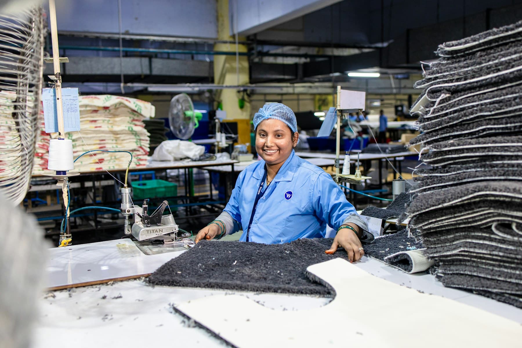 A production manager and operator reviewing activity on a manufacturing floor