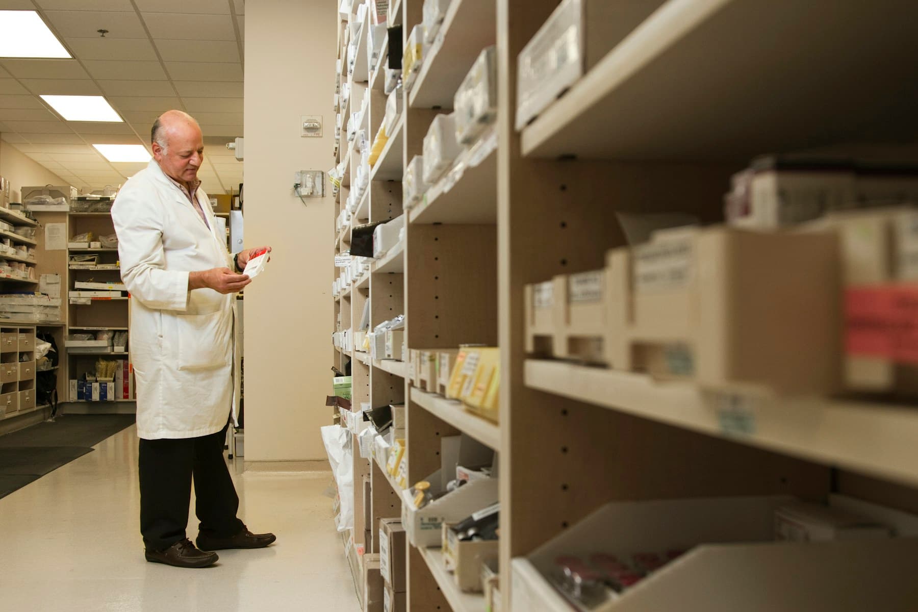 A pharmacist reviewing medicine inventory with a colleague
