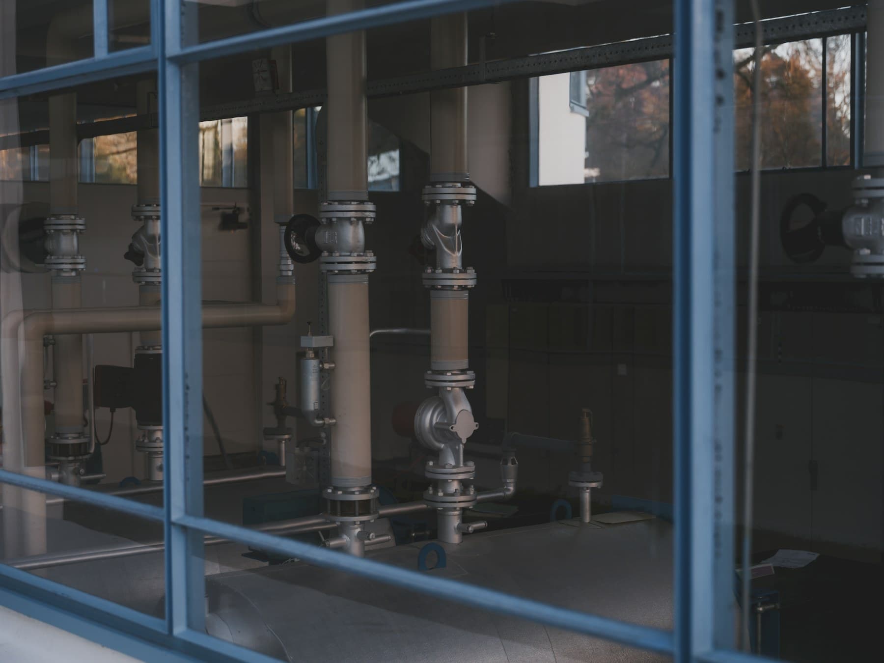 A pipe manufacturing team inspecting finished production on the factory floor