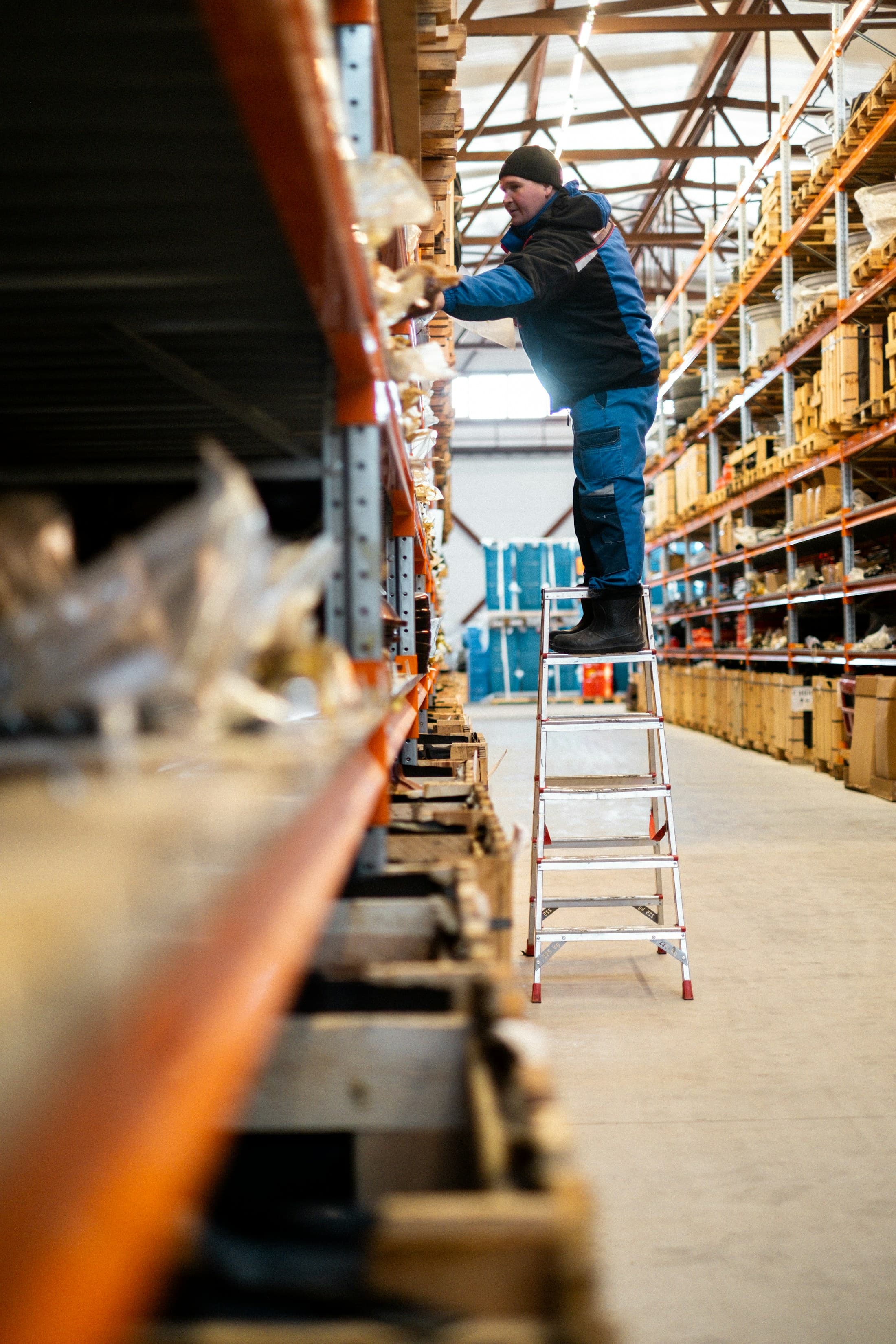 Warehouse operator handling inventory on industrial shelving